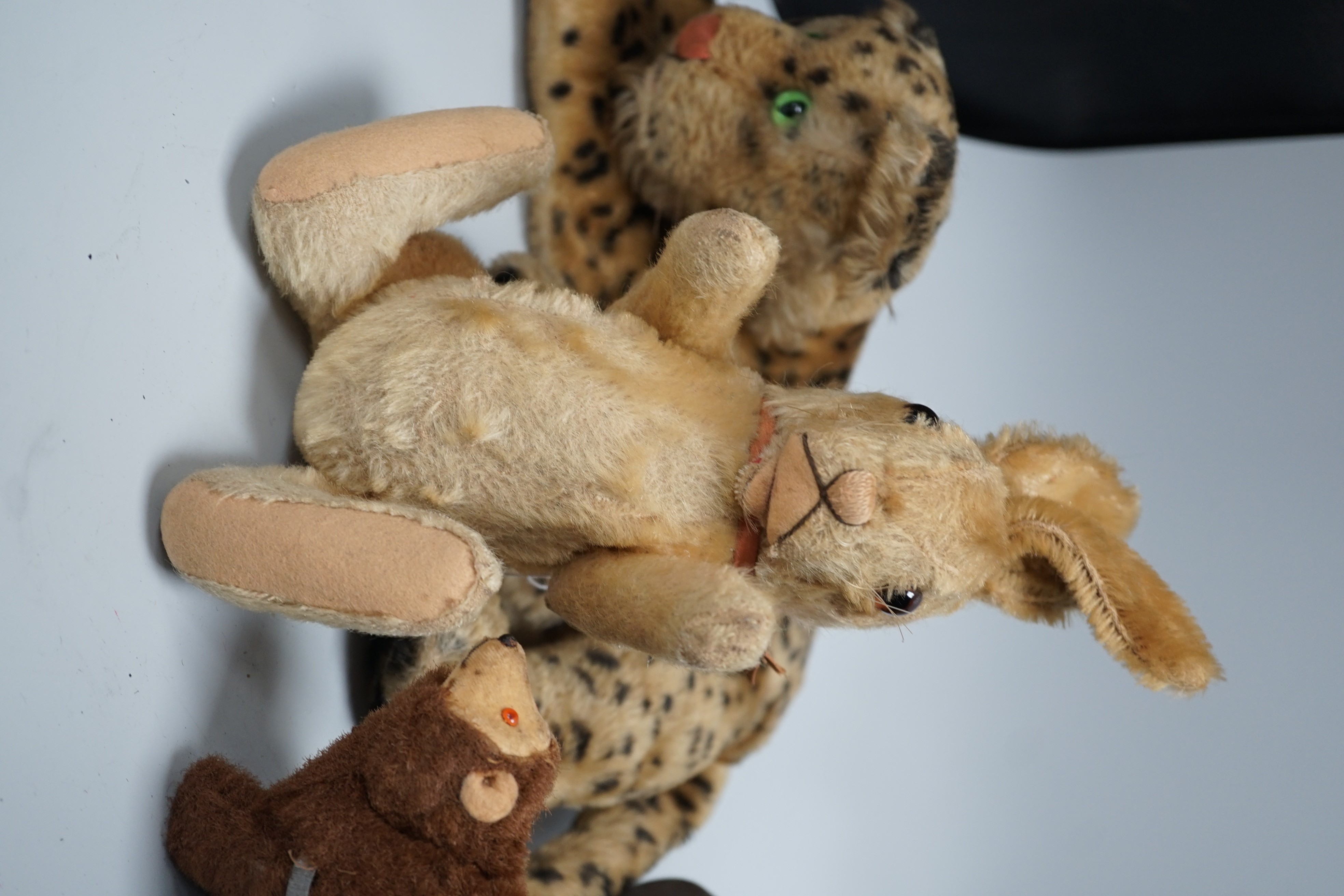 Three Steiff soft toys and a Japanese clockwork bear